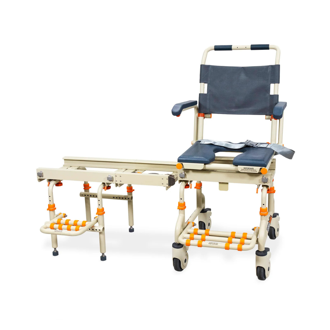 The ShowerBuddy SB2 TubBuddy Bathing System features a rolling chair with a detachable sliding bench, padded seat, backrest, armrests, safety belt, footrests, and orange accents for safer accessible bathing and reduced caregiver strain.
